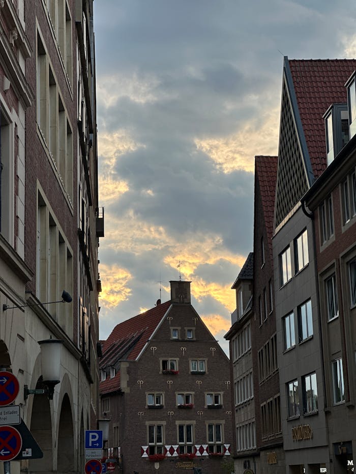 Charming street in Münster, Germany, highlighting historic architecture under evening clouds.